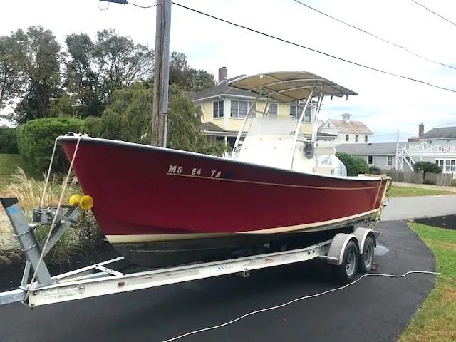 Slide: The Image of Red 2007 Bristol Harbor 21 CC boat on trailer in residential area. - 3