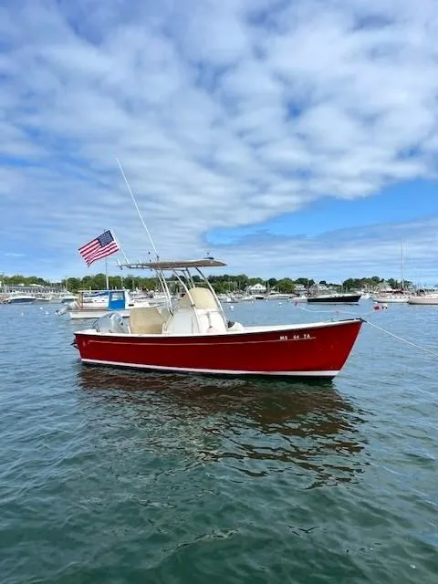 Slide: The Image of Red 2007 Bristol Harbor 21 CC boat with American flag on calm water. - 4