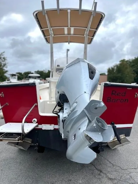 Slide: The Image of 2007 Bristol Harbor 21 CC boat with outboard motor, red hull, and "Red Baron" text. - 8