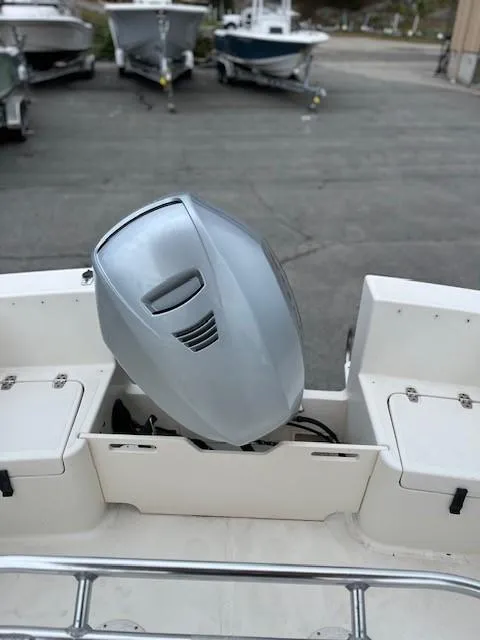 Slide: The Image of 2007 Bristol Harbor 21 CC boat with outboard motor in a marina setting. - 9