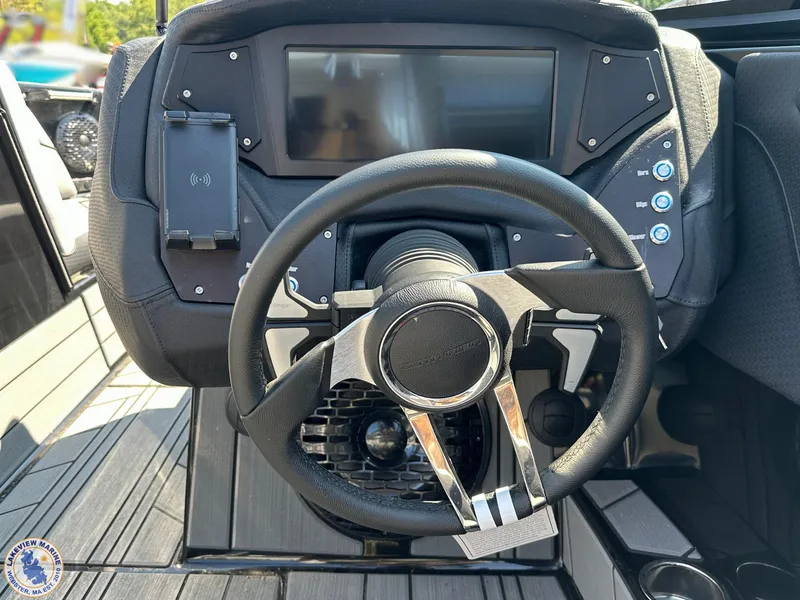 Slide: The Image of 2023 Centurion Vi22 boat dashboard with steering wheel and touchscreen display. - 12