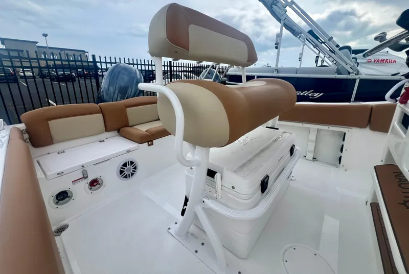 Slide: The Image of 2025 NauticStar 212 Legacy boat with Yamaha engine on display in a marina. - 3
