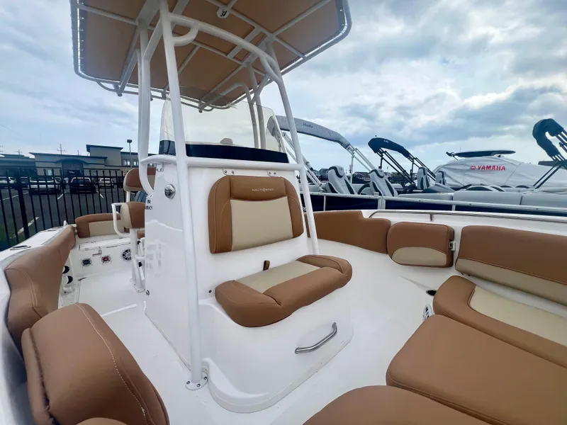 Slide: The Image of 2025 NauticStar 212 Legacy boat interior with tan seating and white deck. - 5