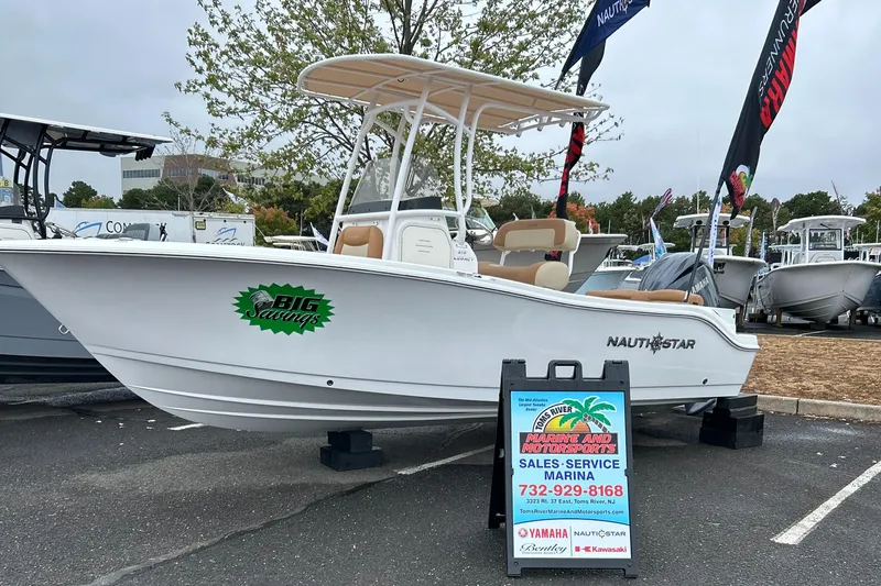 Slide: The Image of 2025 NauticStar 212 Legacy boat dashboard with steering wheel and controls. - 9