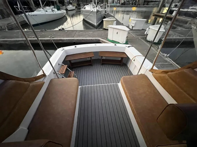 Slide: The Image of 1999 Mainship 30 boat interior with seating, docked at marina. - 7