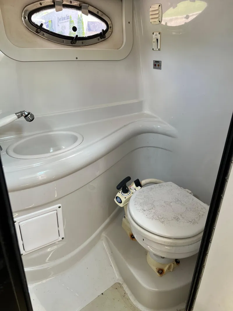 Slide: The Image of 2006 Crownline 250cr boat bathroom with sink and toilet. - 12