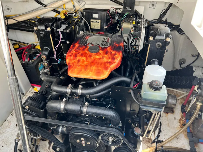 Slide: The Image of Engine compartment of a 2006 Crownline 250cr boat with custom flame-painted cover. - 13