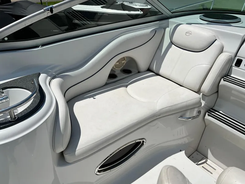 Slide: The Image of 2006 Crownline 250cr boat interior with white seating and built-in cup holders. - 4