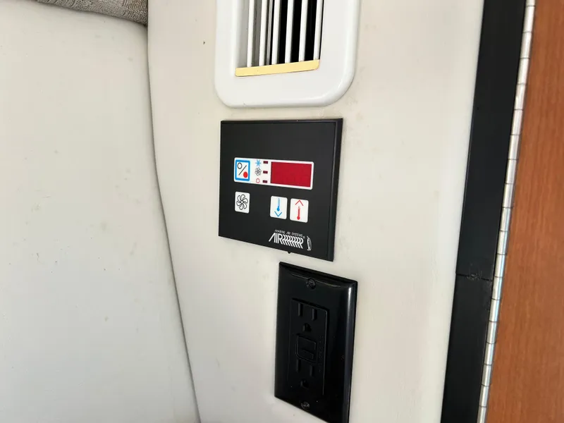 Slide: The Image of Control panel and outlet on 2006 Crownline 250CR boat interior. - 7