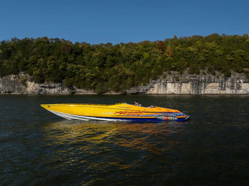 The Image of 2007 Cigarette 42X speedboat on a scenic lake with forested cliffs. - 0