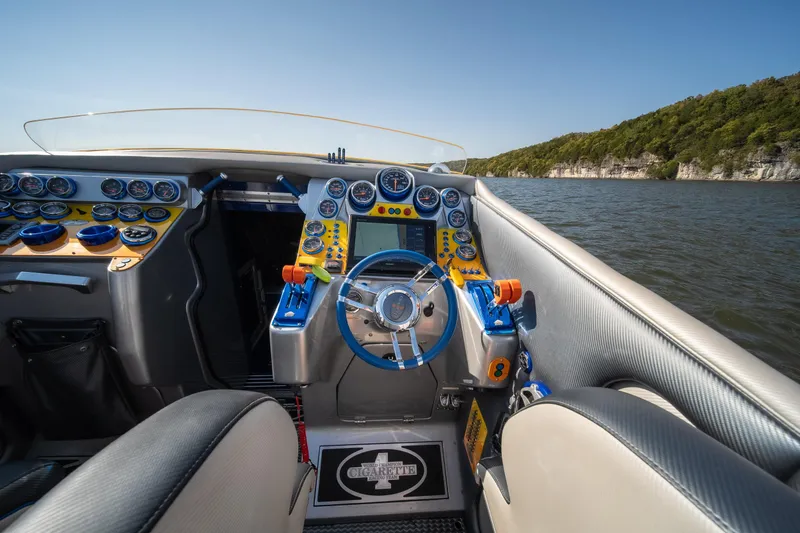 Slide: The Image of 2007 Cigarette 42X boat cockpit with vibrant controls and scenic water view. - 10