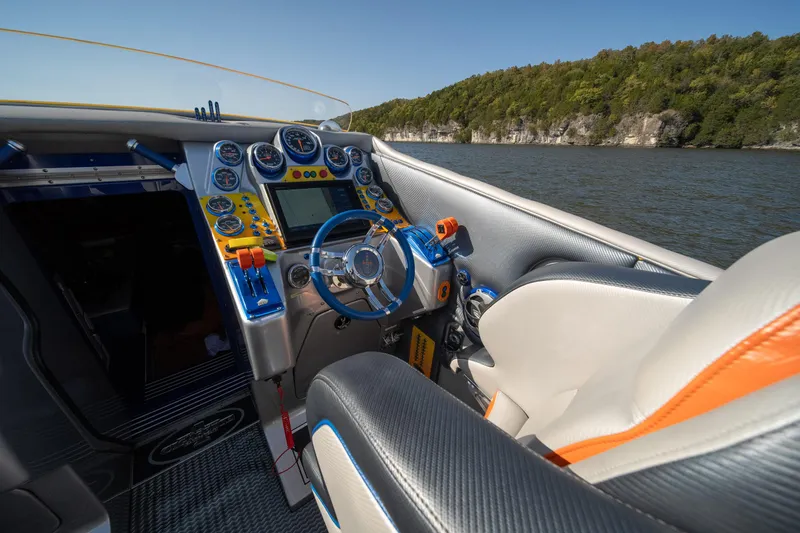 Slide: The Image of 2007 Cigarette 42X boat cockpit with vibrant controls and scenic water view. - 15