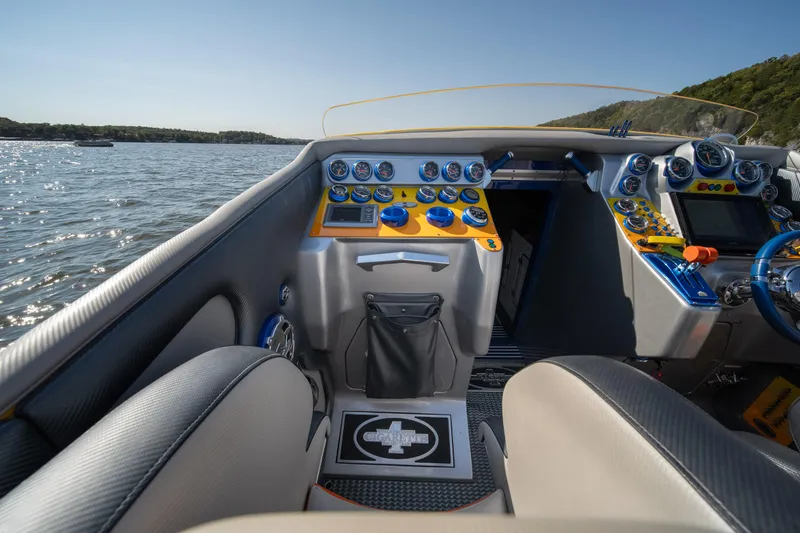 Slide: The Image of Interior of 2007 Cigarette 42X boat with detailed dashboard and lake view. - 16
