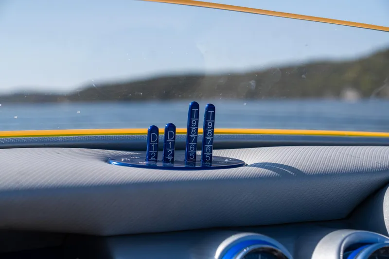 Slide: The Image of Dashboard of a 2007 Cigarette 42X boat with blue control indicators. - 21