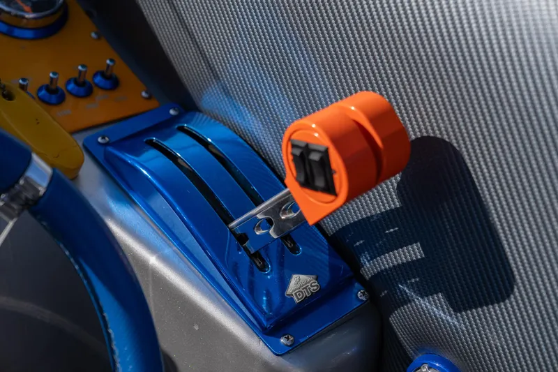 Slide: The Image of Close-up of 2007 Cigarette 42X boat controls with vibrant blue and orange accents. - 23