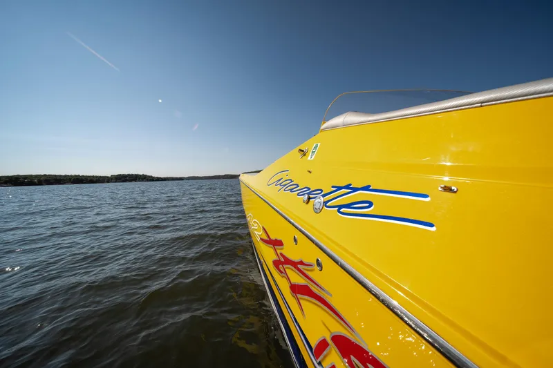 Slide: The Image of Yellow 2007 Cigarette 42X speedboat on open water under clear blue sky. - 26