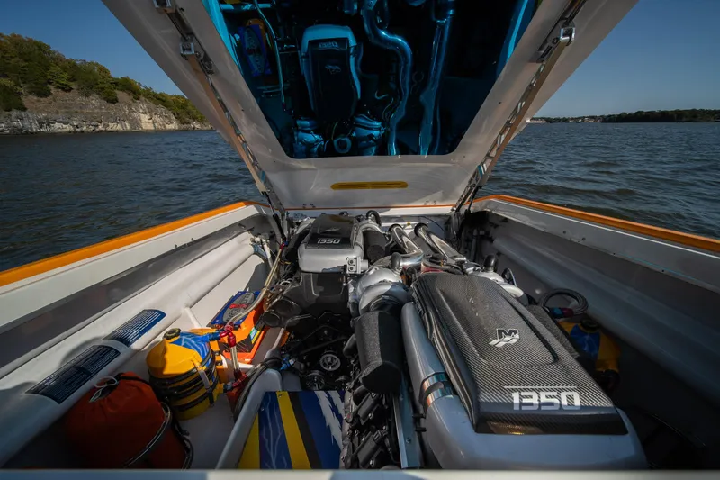 Slide: The Image of 2007 Cigarette 42X boat engine compartment with open hatch on a lake. - 29