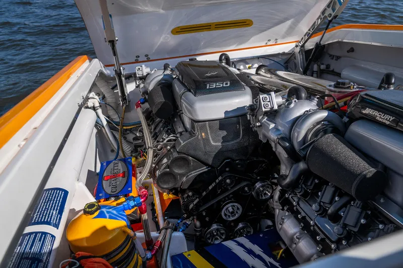 Slide: The Image of 2007 Cigarette 42X boat engine compartment with Mercury 1350 engine, docked by water. - 33