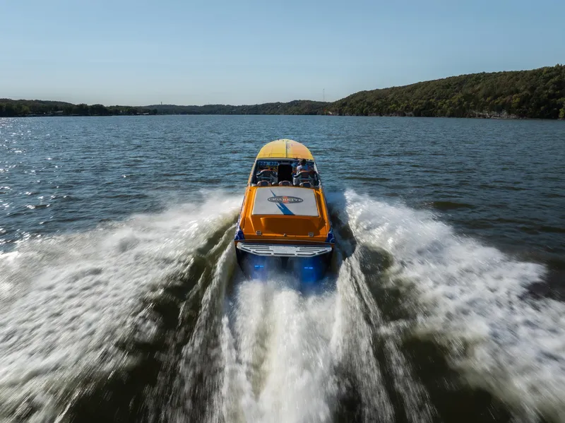 Slide: The Image of 2007 Cigarette 42X speedboat cruising on a lake, creating a dynamic wake. - 4