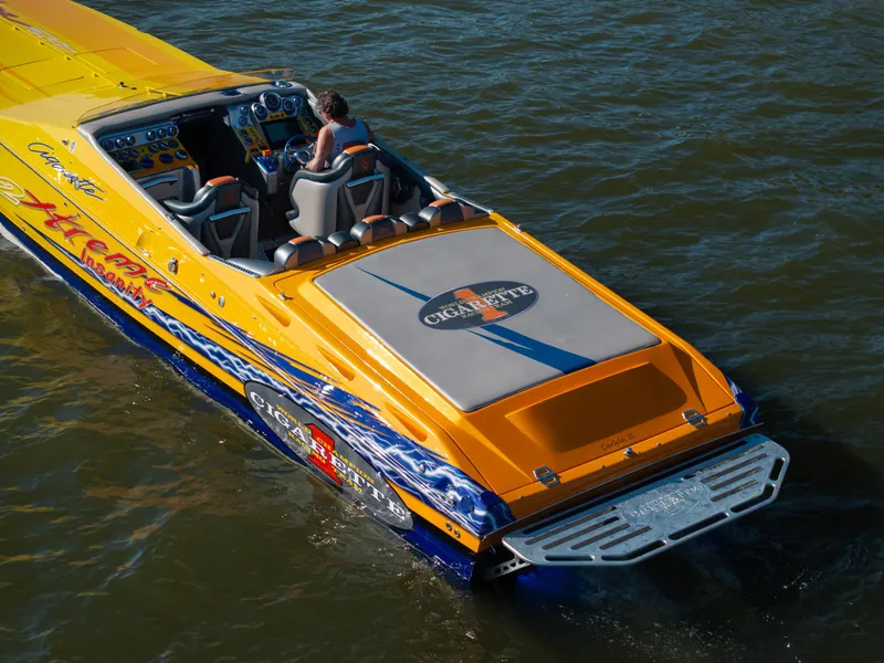 Slide: The Image of Bright yellow 2007 Cigarette 42X speedboat on water, featuring sleek design and vibrant graphics. - 6