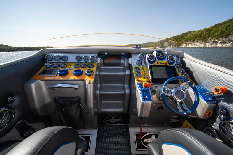 Slide: The Image of 2007 Cigarette 42X boat cockpit with advanced controls and vibrant dashboard on a sunny day. - 9