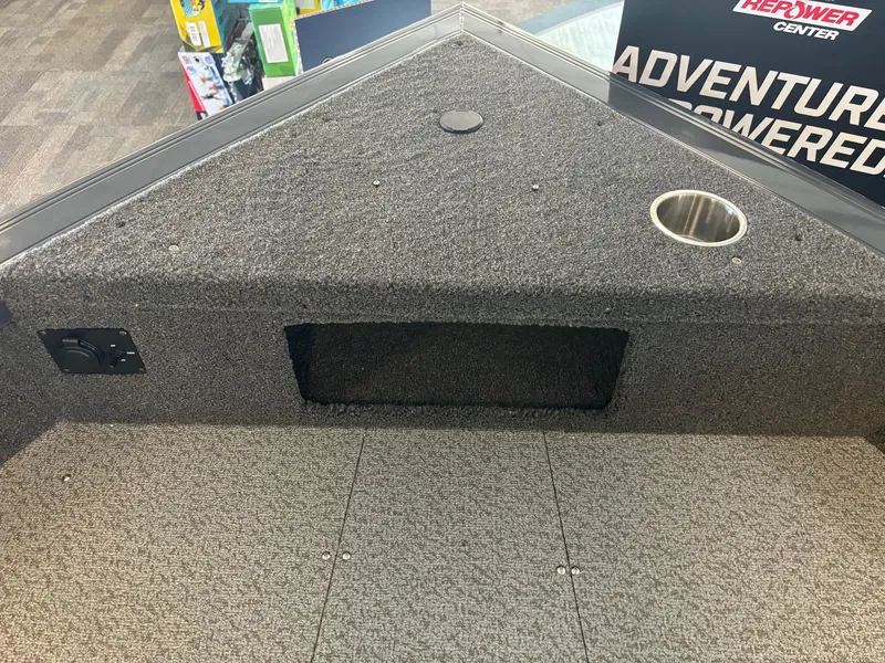 Slide: The Image of 2025 Crestliner 1750 Fish Hawk WT JS boat interior with carpeted deck and cup holder. - 9