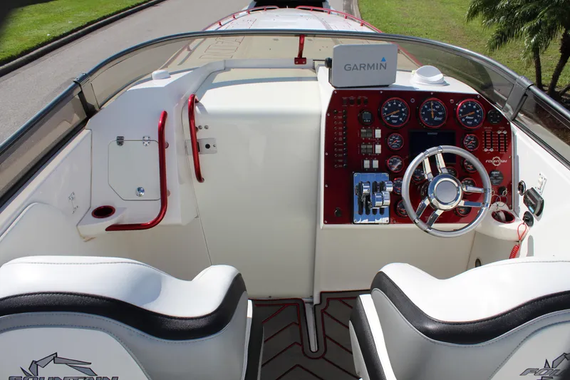 Slide: The Image of 2007 Fountain 42 Lightning boat cockpit with Garmin navigation system and red accents. - 32