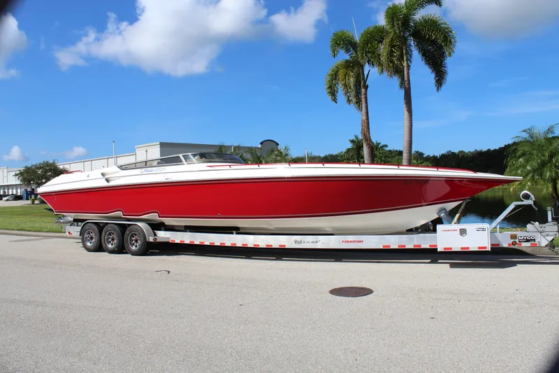 Slide: The Image of Red 2007 Fountain 42 Lightning boat on trailer, parked near palm trees. - 6