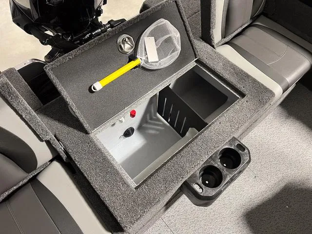 Slide: The Image of 2025 Lund 2075 Tyee Sport boat interior with storage compartment and cup holders. - 12