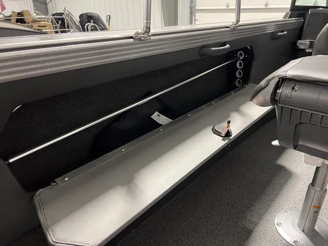 Slide: The Image of Interior view of 2025 Lund 2075 Tyee Sport boat, featuring seating and storage. - 14