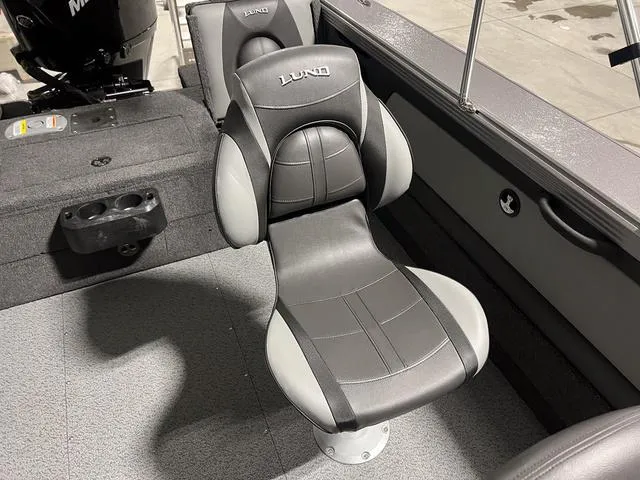 Slide: The Image of 2025 Lund 2075 Tyee Sport boat interior with gray cushioned seat. - 16