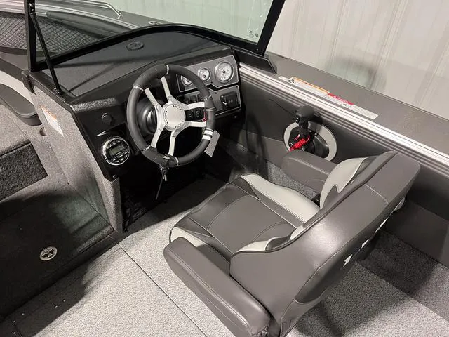 Slide: The Image of Interior of 2025 Lund 2075 Tyee Sport boat with steering wheel and seat. - 18