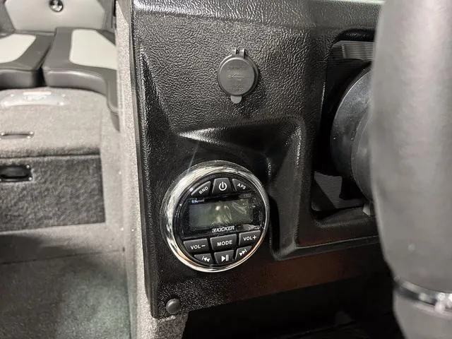 Slide: The Image of 2025 Lund 2075 Tyee Sport boat dashboard with Kicker audio controls. - 20