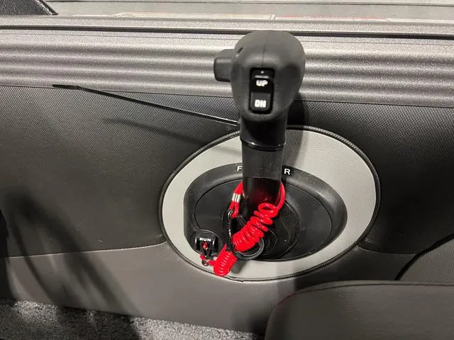 Slide: The Image of Lund 2075 Tyee Sport 2025 boat throttle control with red coiled safety cord. - 21