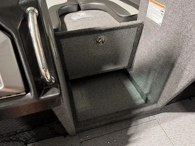 Slide: The Image of Interior of 2025 Lund 2075 Tyee Sport boat, featuring storage compartment. - 24