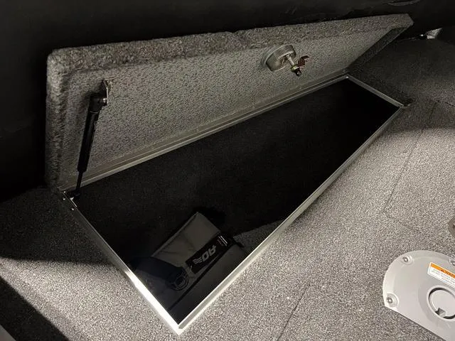 Slide: The Image of Open storage compartment in 2025 Lund 2075 Tyee Sport boat. - 26