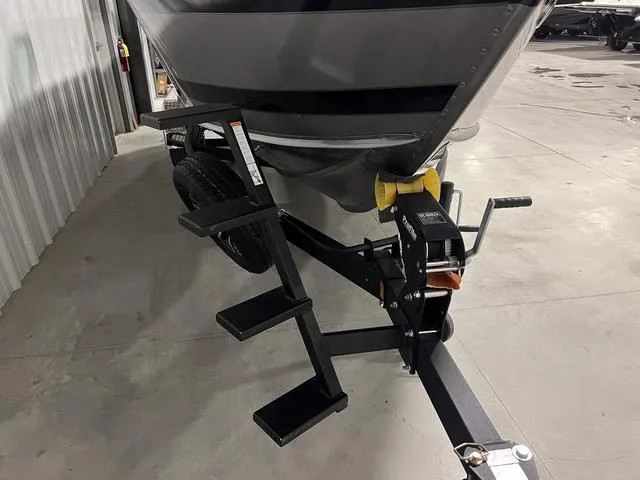 Slide: The Image of 2025 Lund 2075 Tyee Sport boat on trailer with steps in a garage. - 3