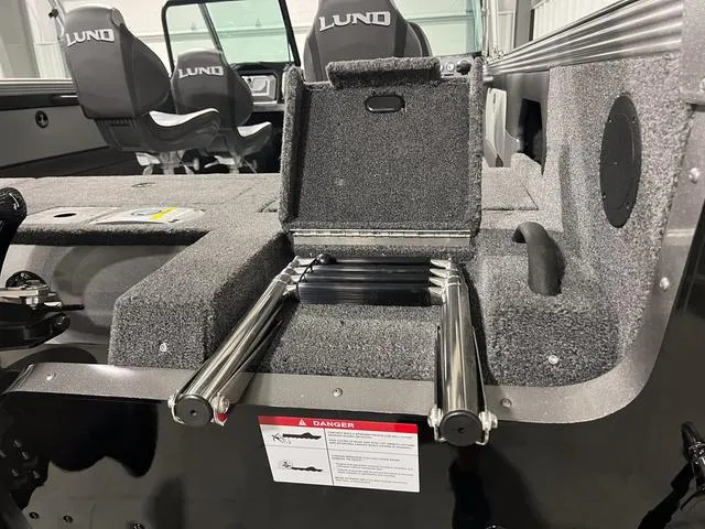 Slide: The Image of 2025 Lund 2075 Tyee Sport boat interior with foldable ladder and seating. - 5