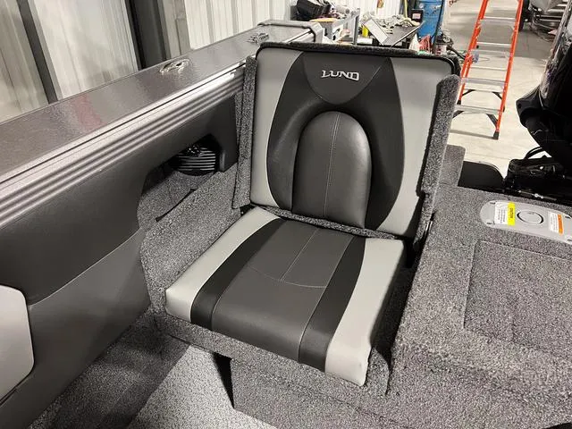 Slide: The Image of 2025 Lund 2075 Tyee Sport boat seat, gray and black upholstery. - 7