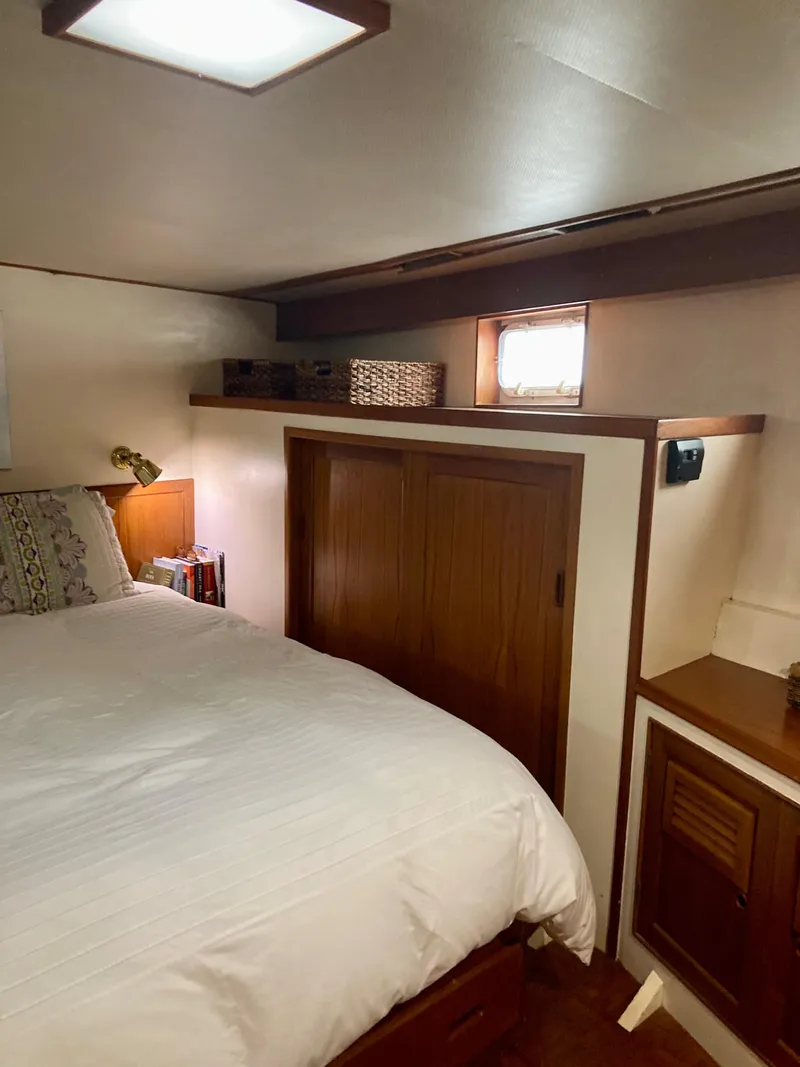 Slide: The Image of Cozy bedroom in 1977 Grand Alaskan Raised Pilothouse with wood accents and natural light. - 16