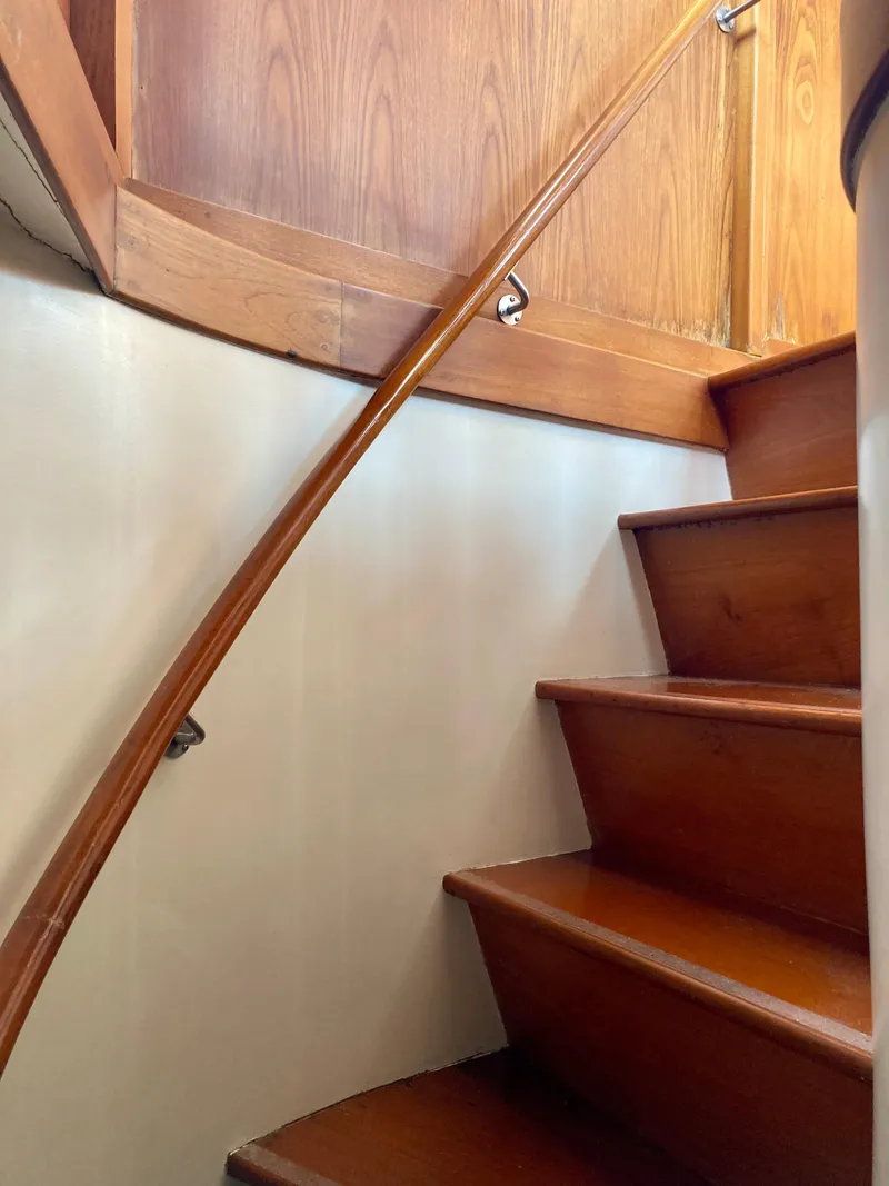 Slide: The Image of Wooden staircase inside 1977 Grand Alaskan Raised Pilothouse yacht. - 20