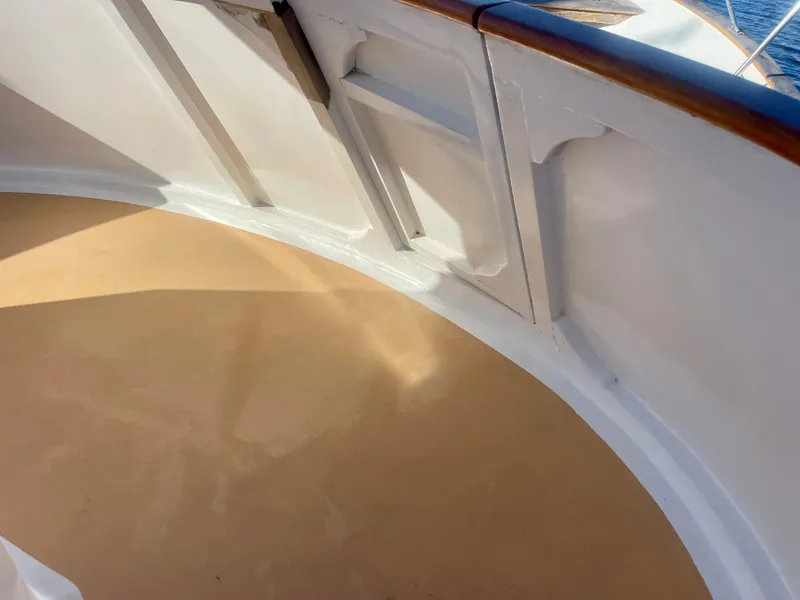 Slide: The Image of Deck view of 1977 Grand Alaskan Raised Pilothouse yacht with wooden railings. - 23