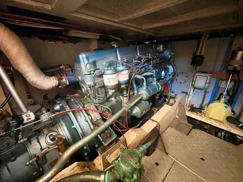 Slide: The Image of Engine room of 1977 Grand Alaskan Raised Pilothouse yacht, showcasing detailed machinery. - 30