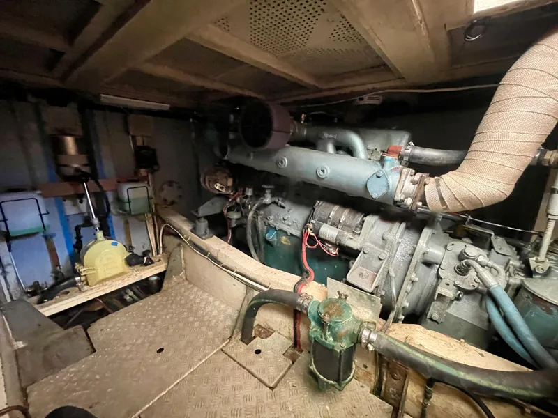 Slide: The Image of Engine room of 1977 Grand Alaskan Raised Pilothouse with visible machinery and pipes. - 31