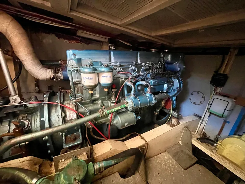 Slide: The Image of Engine room of 1977 Grand Alaskan Raised Pilothouse, showcasing detailed machinery and components. - 32
