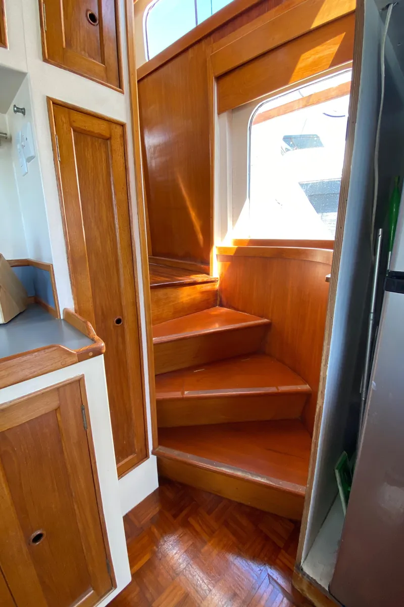 Slide: The Image of Wooden staircase in 1977 Grand Alaskan Raised Pilothouse yacht interior. - 43