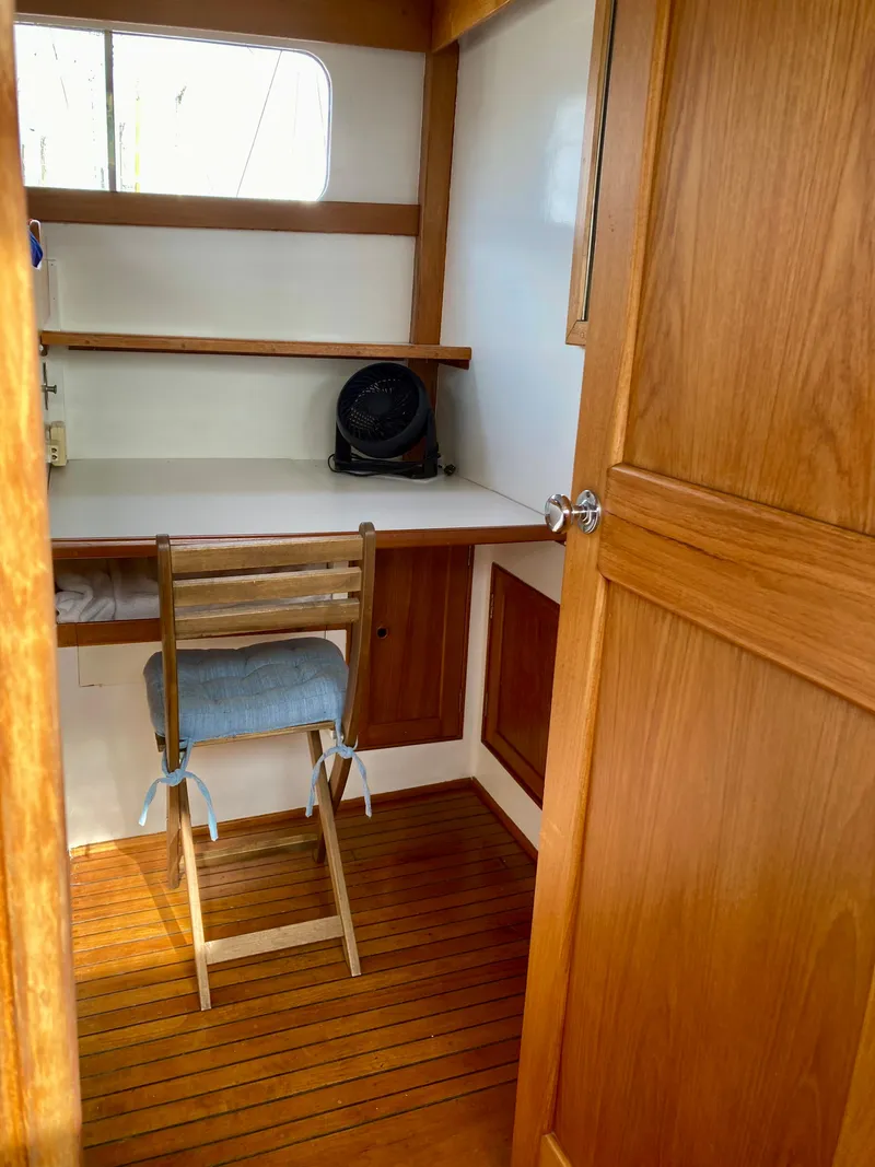 Slide: The Image of 1977 Grand Alaskan Raised Pilothouse interior with wooden desk and chair. - 5