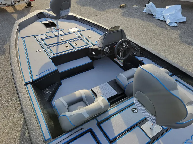 Slide: The Image of 2025 Xpress H17C Crappie boat interior with seating and steering console, in stock. - 10