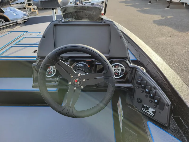 Slide: The Image of 2025 Xpress H17C Crappie boat dashboard with steering wheel and control panel. - 4