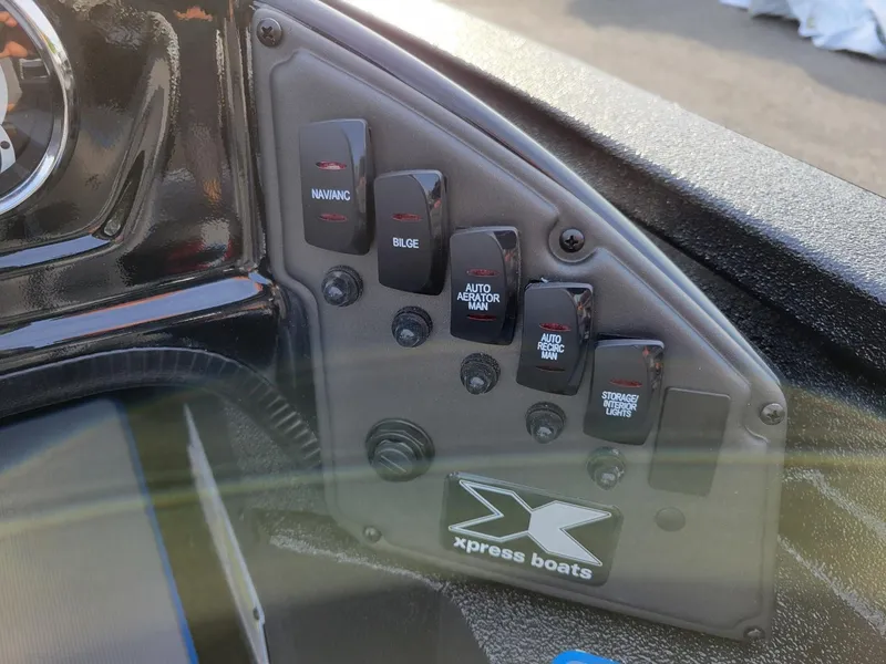 Slide: The Image of Control panel of 2025 Xpress H17C Crappie boat with various switches. - 5